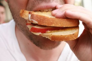 © thebittenword.com Mann isst Sandwich